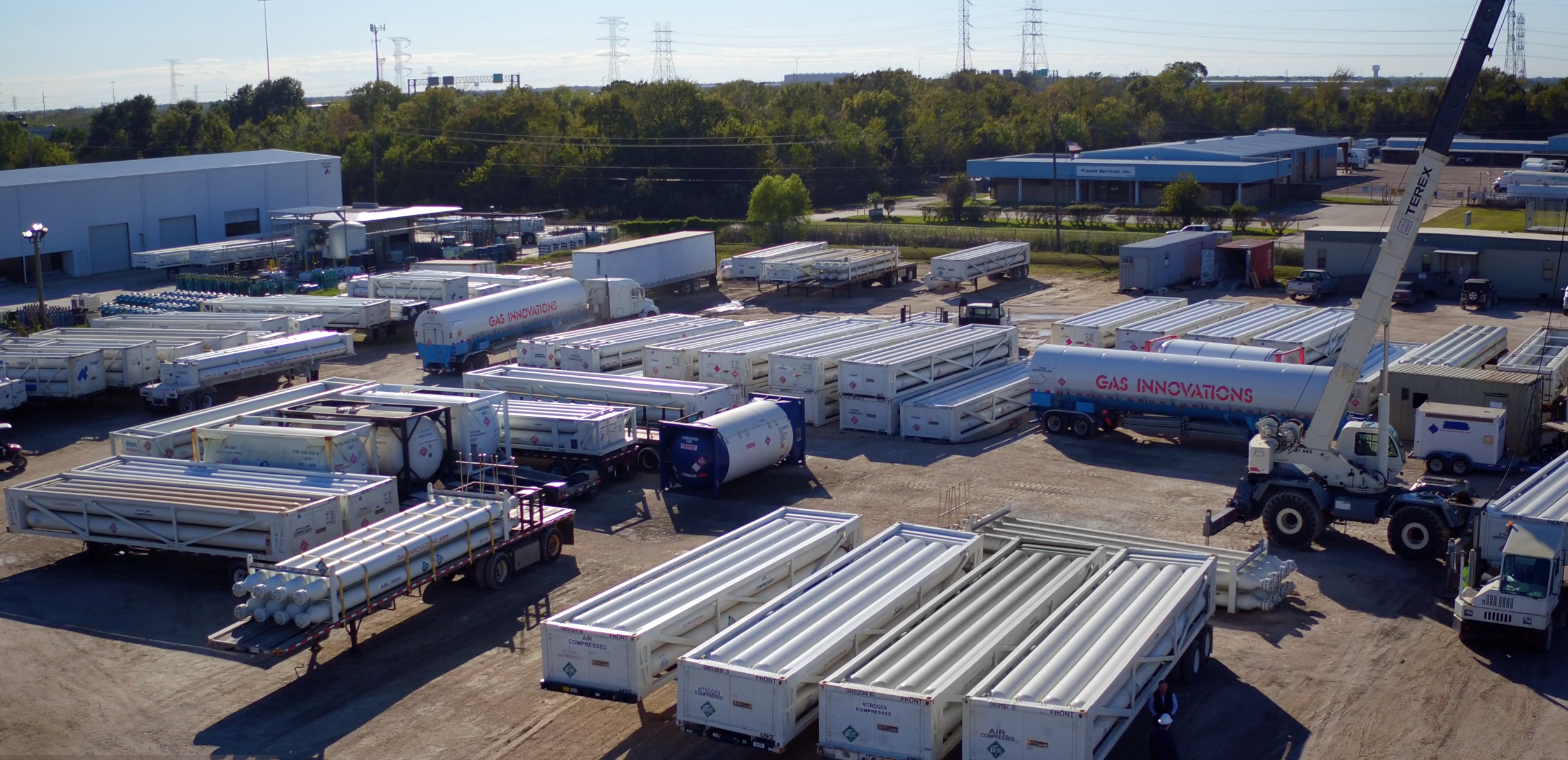 Gas Innovations pure helium gas delivery trucks at an industrial supply facility